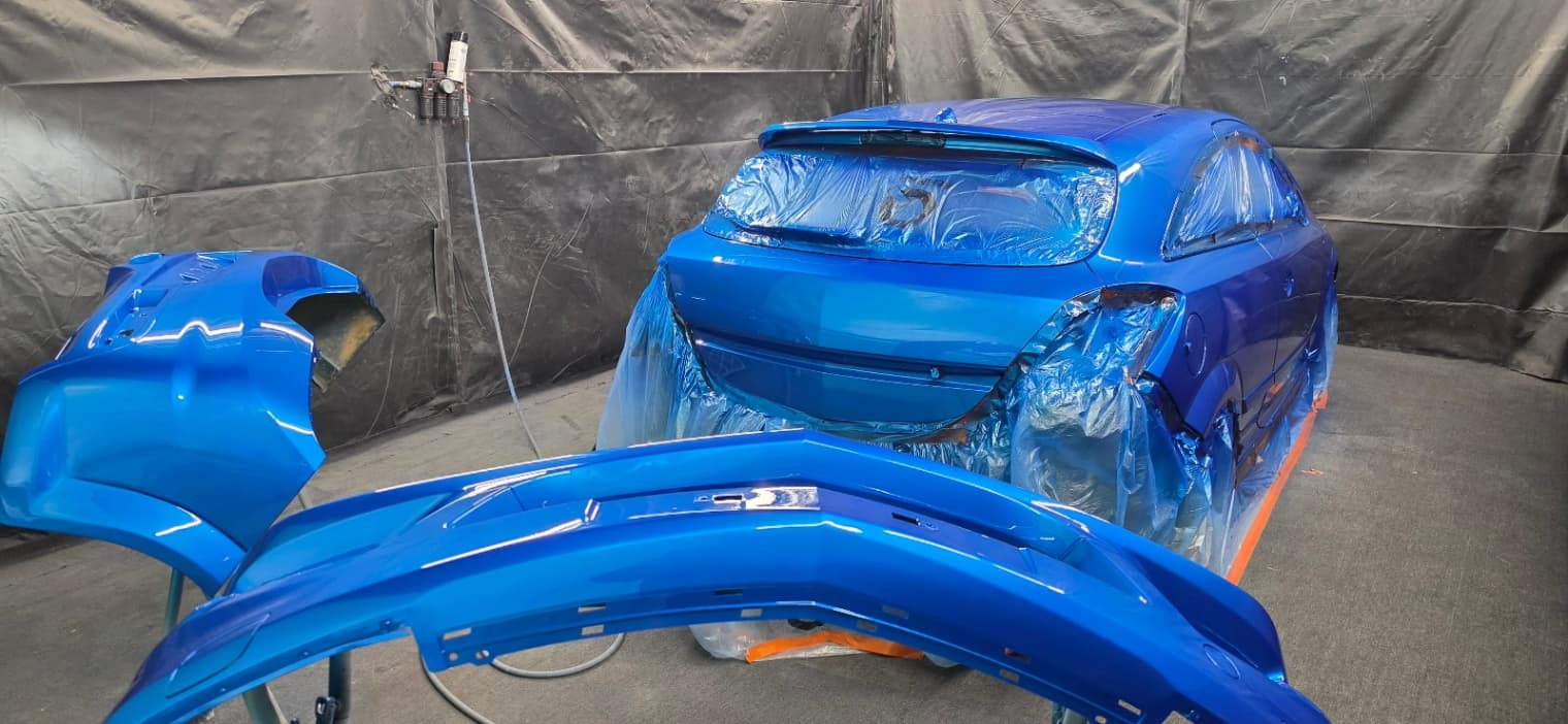 A car being resprayed in the booth